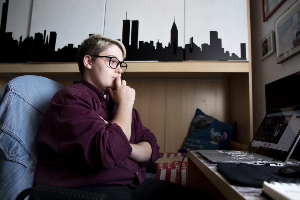 Matteo Coccimiglio attends a virtual school lesson in his room in Rome, Thursday, March 18, 2021. Matteo is an 18-year-old student who identifies as a man and is in the process of changing his legal gender from female to male. The Ripetta school of art in Rome - where he studies - recently joined a handful of high schools in Italy that give transgender students the right to be known by a name other than the one they were given at birth. The initiative is meant to create an environment where transgender students feel secure and reflects a growing awareness in Italy of gender dysphoria among teenagers and children. (AP Photo/Alessandra Tarantino)