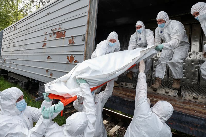 Ukrainian servicemen load refrigerated rail car with bodies of Russian soldiers in Kyiv