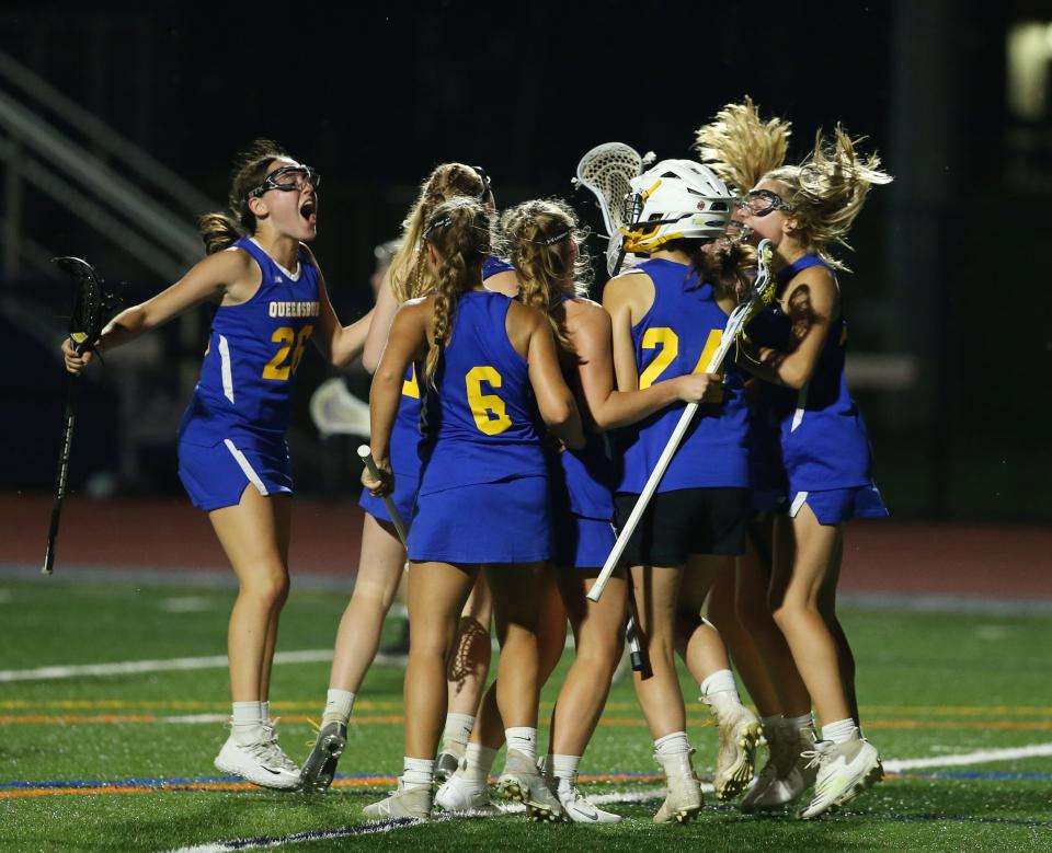 Queensbury's girls lacrosse team celebrates their win over Warwick in Tuesday's Class B sub-regional game on May 31, 2022.