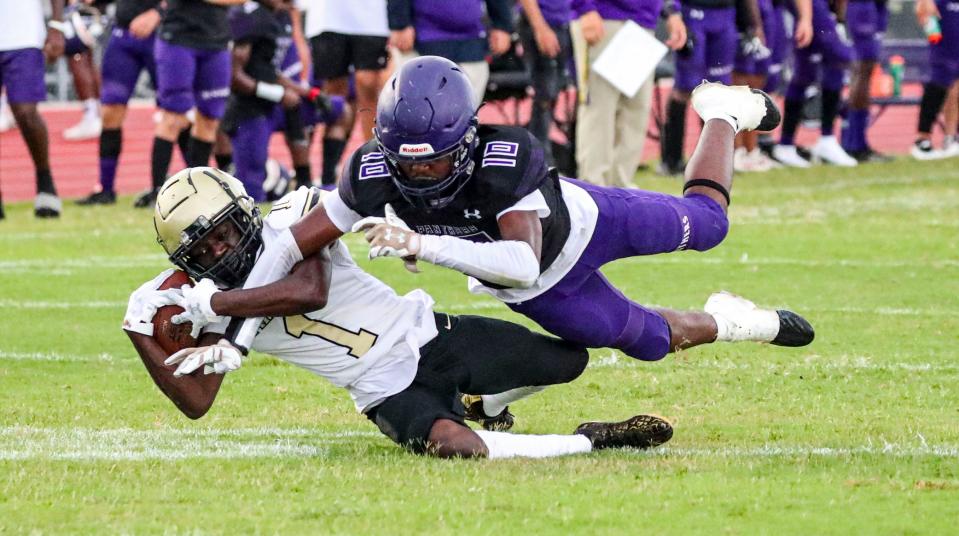 Gateway's Derrique Mytial pulls down the pass intended for Cypress Lake's Jlishawon Daniels and gets the interception. The continuation of Gateway at Cypress Lake High football which started play on Friday.  Canceled because of weather, they resumed play Monday evening, August 29, 2022, at Cypress Lake.