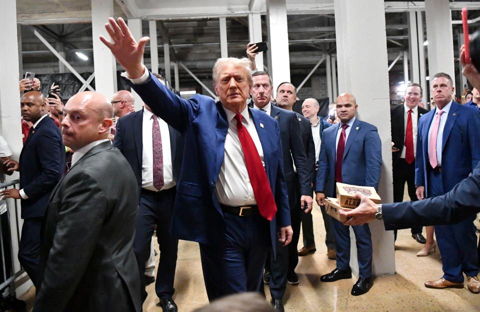 Donald Trump waves to onlookers as her attends the game between Alabama and Georgia at the Bryant-Denny Stadium (USA TODAY Sports via Reuters Con)