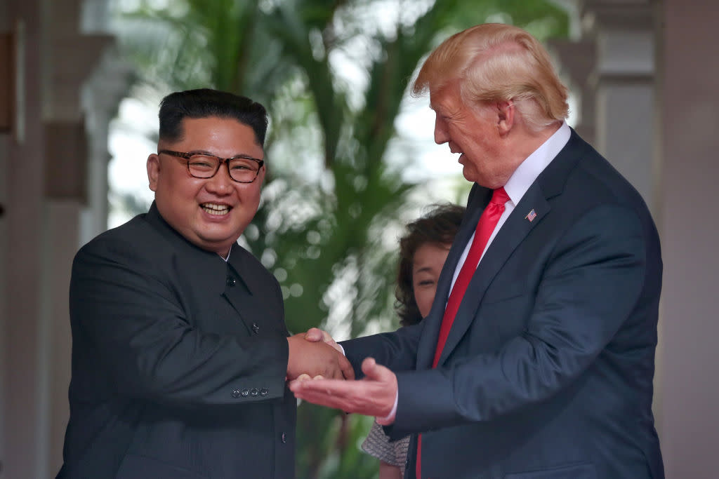 Kim Jong-un smiles as he greets Donald Trump (Picture: Getty)