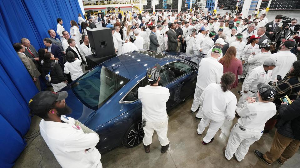 A crowd gathers around Ohio Governor Mike DeWine and the new Honda Accord as the company introduces its new version of the Accord made at the Marysville Auto Plant.