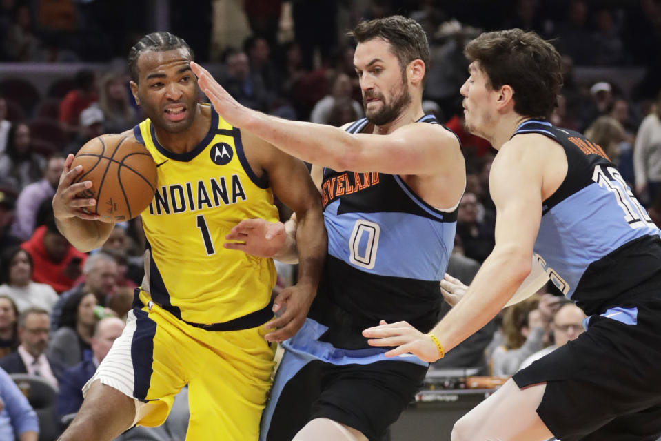 Indiana Pacers' T.J. Warren (1) drives past Cleveland Cavaliers' Kevin Love (0) and Cleveland Cavaliers' Cedi Osman (16) in the second half of an NBA basketball game, Saturday, Feb. 29, 2020, in Cleveland. Indiana won 113-104. (AP Photo/Tony Dejak)