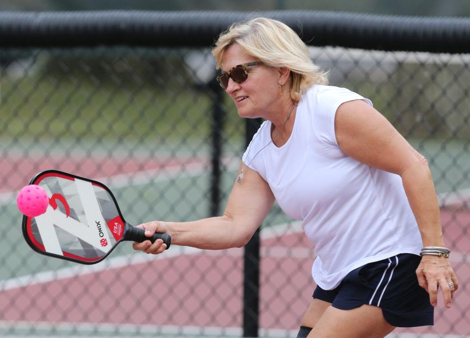 Jennie Parrish plays pickleball against her friend Harry "Hop" Delp at Stadium Park in Canton.