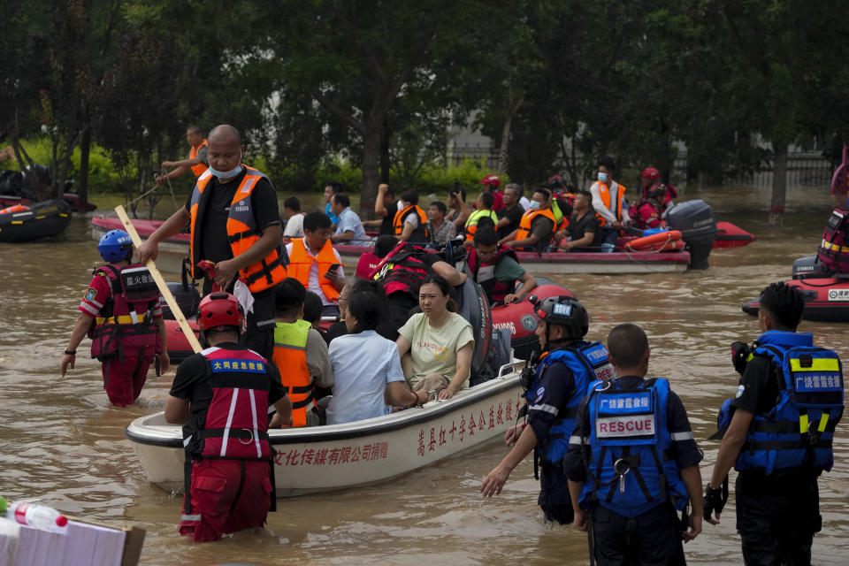 Residents evacuate on boats moving through floodwaters in Zhuozhou in northern China's Hebei province, south of Beijing, Wednesday, Aug. 2, 2023. China's capital has recorded its heaviest rainfall in at least 140 years over the past few days. Among the hardest hit areas is Zhuozhou, a small city that borders Beijing's southwest. (AP Photo/Andy Wong)