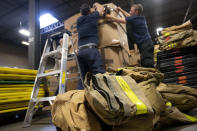 Volunteers with Razom for Ukraine, a New York-based nonprofit, pack firefighting and medical donations for shipment to Ukraine, Wednesday, Feb. 8, 2023, in Woodbridge Township, N.J. (AP Photo/John Minchillo)