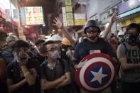 Pro-democracy protesters stand their ground on a barricaded road in the Mong Kok district of Hong Kong on October 23, 2014