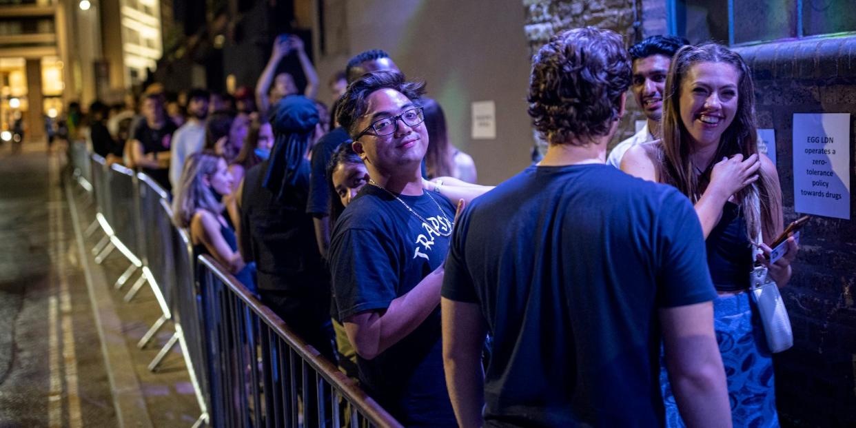 people queueing at night in front of a nightclub