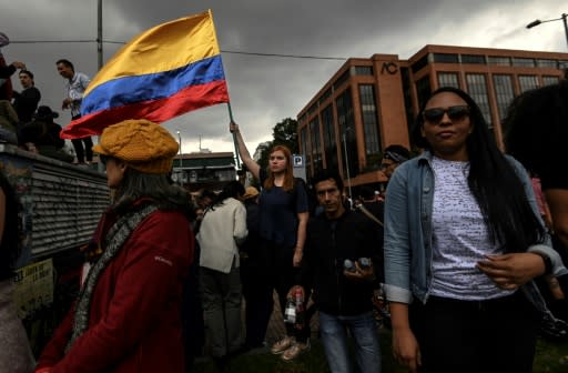 A woman waves a Colombian national flag during a concert organized by Colombian musicians and artists to support protests against the government of President Ivan Duque in Bogota