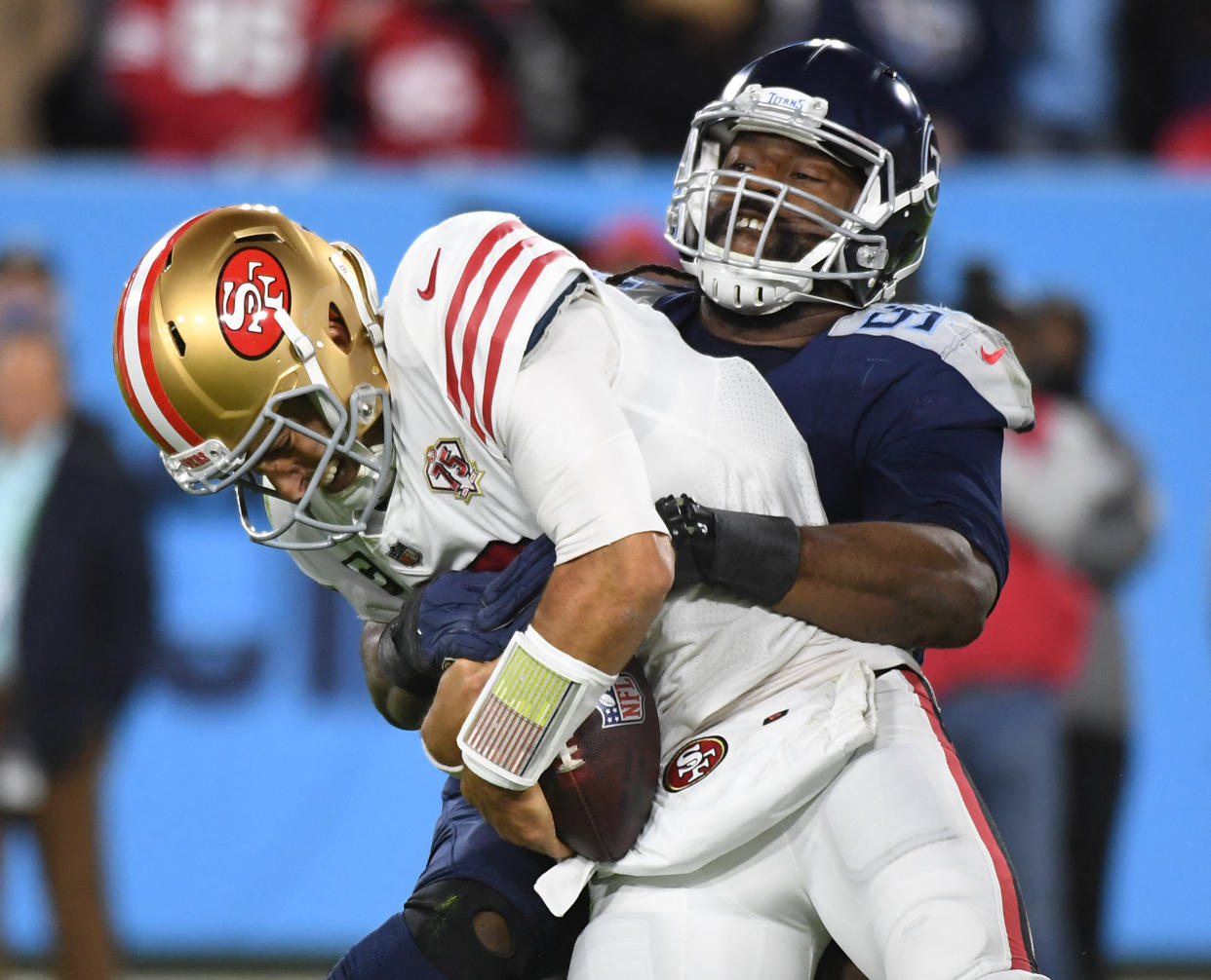 Dec 23, 2021; Nashville, Tennessee, USA; San Francisco 49ers quarterback Jimmy Garoppolo (10) is sacked by Tennessee Titans defensive end Denico Autry (96) during the first half at Nissan Stadium. Mandatory Credit: Christopher Hanewinckel-USA TODAY Sports