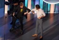 Thomas Rhett, right, winner of the entertainer of the year award, elbow bumps host Keith Urban on stage during the 55th annual Academy of Country Music Awards at the Grand Ole Opry House on Wednesday, Sept. 16, 2020, in Nashville, Tenn. (AP Photo/Mark Humphrey)