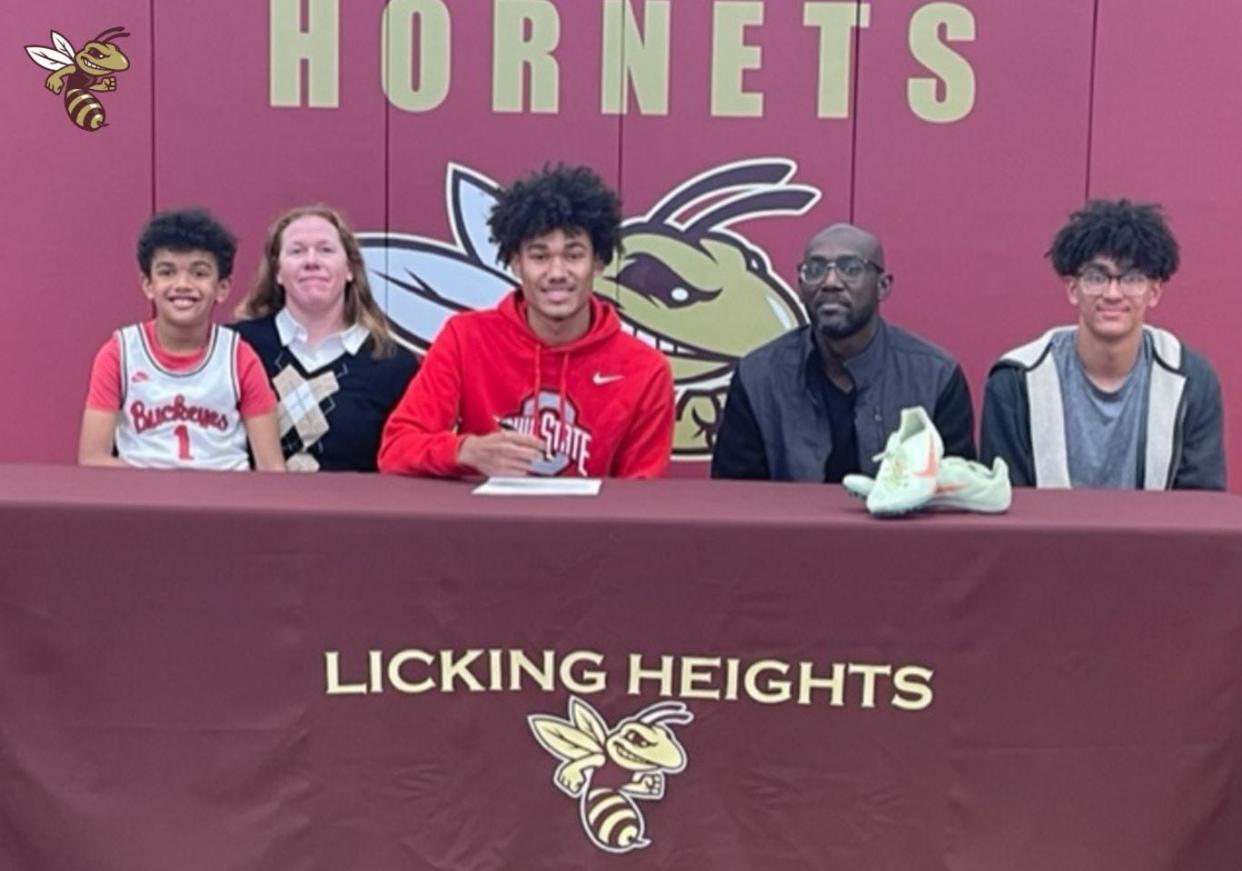 Licking Heights senior D.J. Fillmore, center, signs to join the Track and Field team at The Ohio State University in the fall. Fillmore holds multiple state and school records for sprinting and long jump.