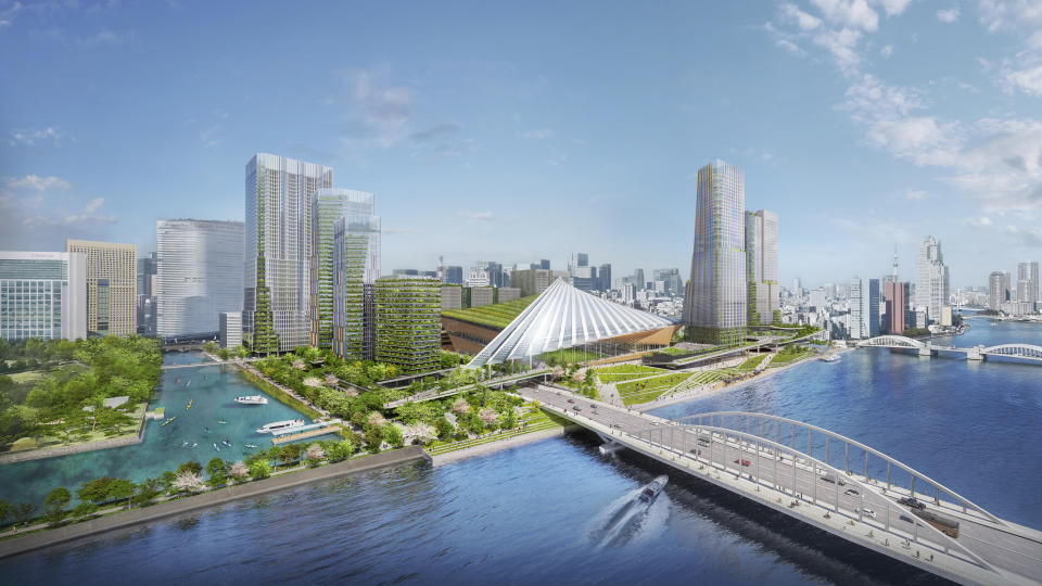 This image provided by ONE PARK×ONE TOWN shows an artist rendering of a waterfront stadium and skyscrapers planned to be built at the site of the former Tsukiji fish market in Tokyo. (ONE PARK×ONE TOWN via AP)