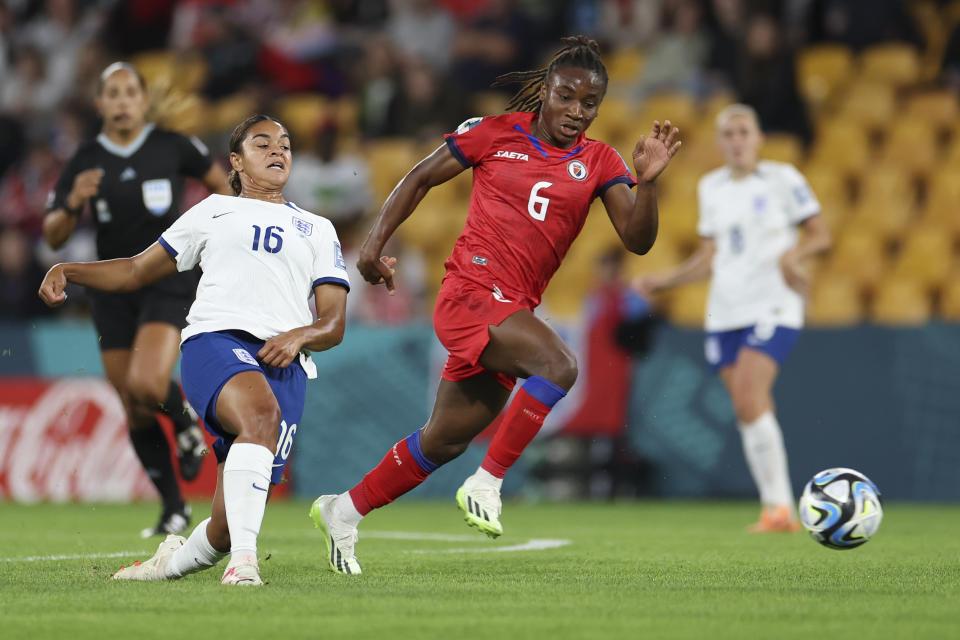 Haiti's Melchie Dumornay, right, gets away from England's Jessica Carter during the Women's World Cup Group D soccer match between England and Haiti in Brisbane, Australia, Saturday, July 22, 2023. (AP Photo/Katie Tucker)