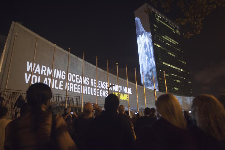 Messages on methane gas and carbon dioxide emissions are projected onto the United Nations building ahead of the climate change talks that will take place on the sidelines of the U.N. General Assembly, in New York September 20, 2014. REUTERS/Carlo Allegri (UNITED STATES - Tags: POLITICS ENVIRONMENT)