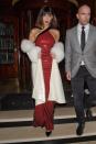 <p>In a red sequined asymmetrical dress by Ralph Lauren, lace-up Liudmila boots, and a white fur-lined coat while heading to the Tag Heuer opening in London.</p>