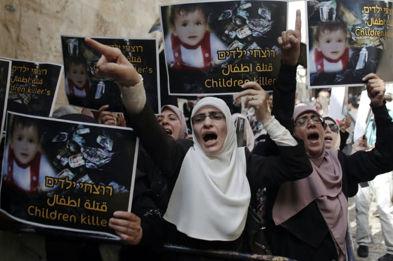 Palestinians take part in a protest against the death of an 18-month-old child killed in an arson attack in the occupied West Bank, on August 2, 2015