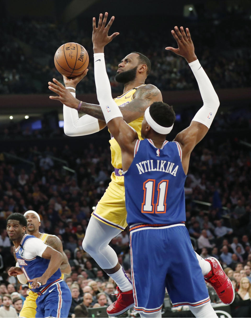 New York Knicks guard Frank Ntilikina (11) defends as Los Angeles Lakers forward LeBron James (23) goes up for two points during the first half of an NBA basketball game in New York, Wednesday, Jan. 22, 2020. (AP Photo/Kathy Willens)