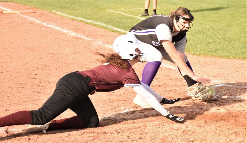 Frankfort-Schuyler Maroon Knight Milana Rocco dives for home plate while Little Falls pitcher Makena Tooley (right) takes a thow from the Mountie catcher Monday in Frankfort. The teams play again Tuesday in Little Falls.