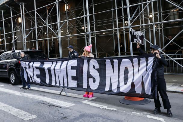 PHOTO: Demonstrators hold a banner after former President Donald Trump's indictment by a Manhattan grand jury following a probe into hush money paid to porn star Stormy Daniels, in New York, March 30, 2023. (Jeenah Moon/Reuters)