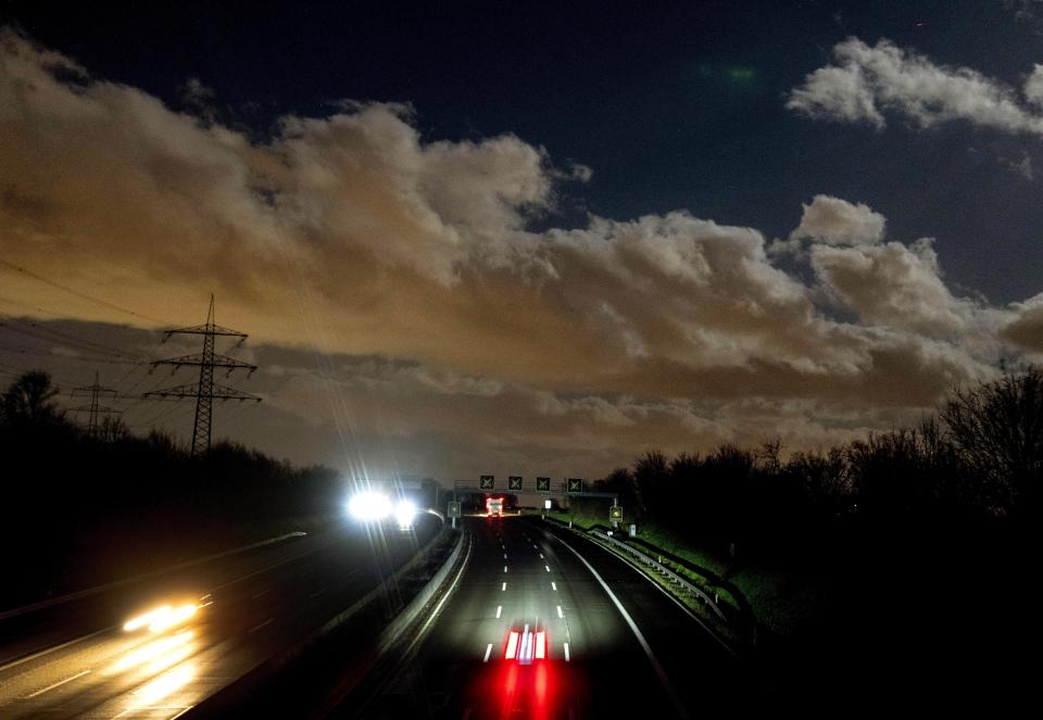 Clouds drift over a highway in Frankfurt, Germany, on a stormy Thursday, Feb. 17, 2022. Large parts of Germany are hit by a heavy storm on Thursday. (AP Photo/Michael Probst)