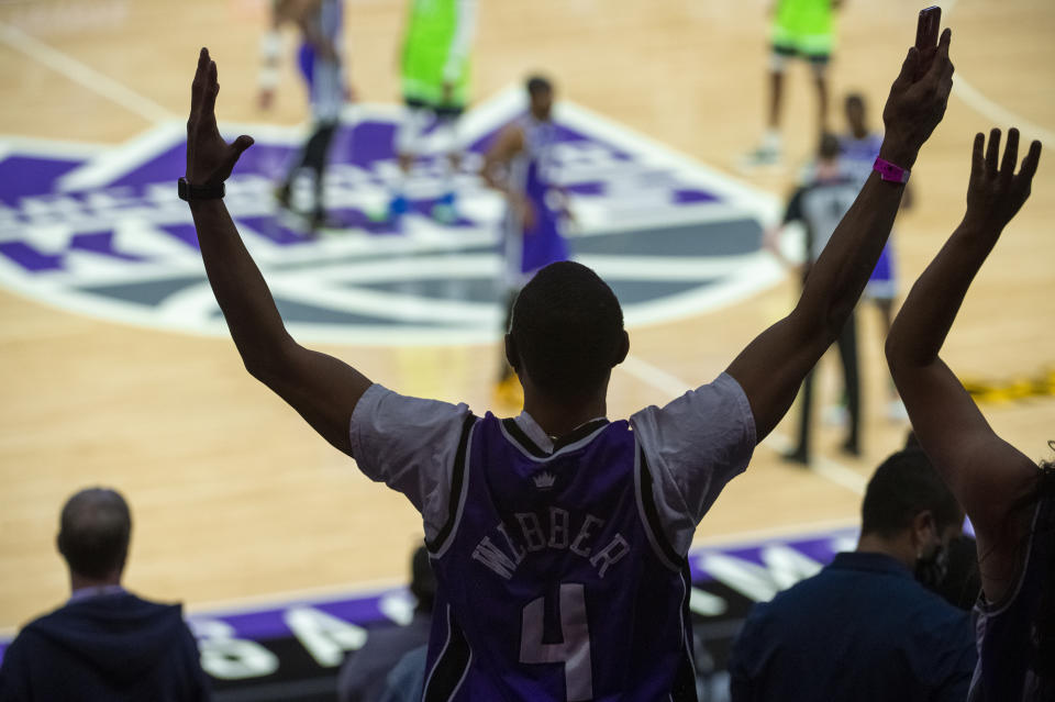 Joseph Colvin cheers from the stands during the first quarter of an NBA basketball game between the Minnesota Timberwolves and the Sacramento Kings in Sacramento, Calif., Tuesday, April 20, 2021. (AP Photo/Randall Benton)