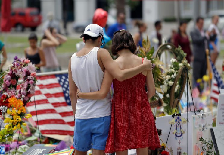 Mourners look at tributes following an attack on Pulse nightclub in Florida last year (Rex)