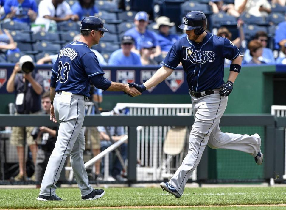 Tampa Bay’s C.J. Cron is congratulated by third base coach Matt Quatraro on a solo home run in the third inning against the Kansas City Royals on May 16, 2018, at Kauffman Stadium in Kansas City, Mo.