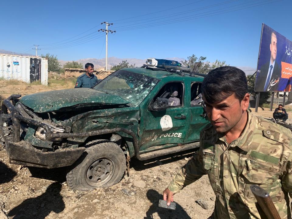 Afghan police inspect the site of a suicide attack, in Parwan province of Afghanistan, Tuesday, Sept. 17, 2019. The Taliban suicide bomber on a motorcycle targeted a campaign rally by President Ashraf Ghani in northern Afghanistan on Tuesday, killing at over 20 people and wounding over 30. Ghani was present at the venue but was unharmed, according to his campaign chief. (AP Photo/Rahmat Gul)