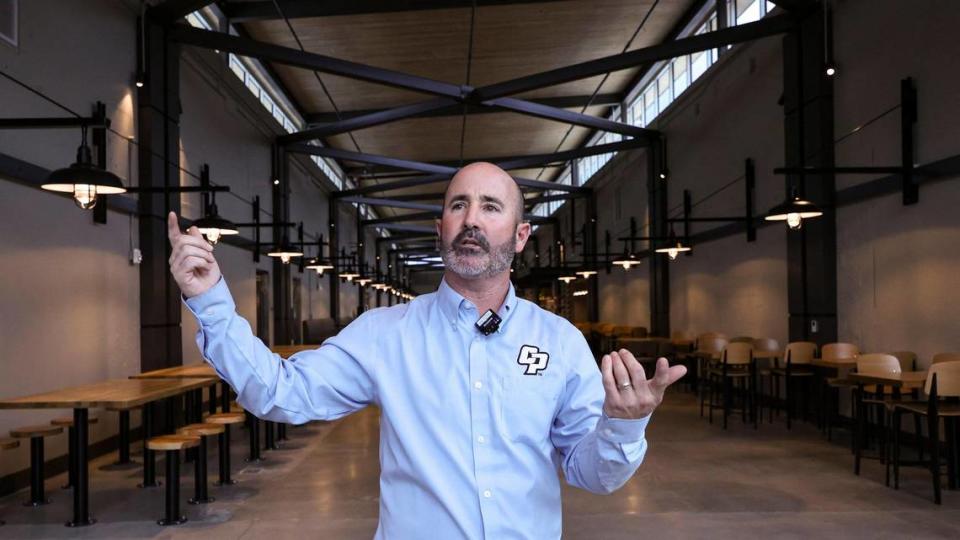 Russell Monteath, director of commercial services with the Cal Poly Corp., leads a tour of the newly renovated 1901 Marketplace dinin complex on Friday, Jan. 19, 2024.