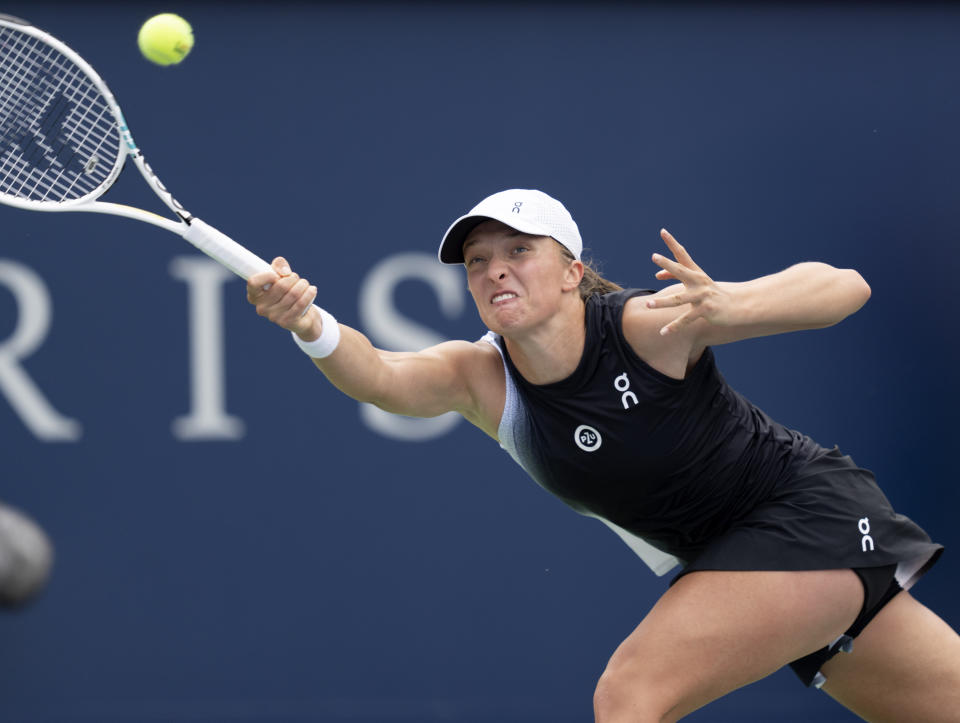 Iga Swiatek of Poland, reaches for a shot against Jessica Pegula of the United States, during the semifinals of the National Bank Open women’s tennis tournament Saturday, Aug. 12, 2023, in Montreal. (Christinne Muschi/The Canadian Press via AP)