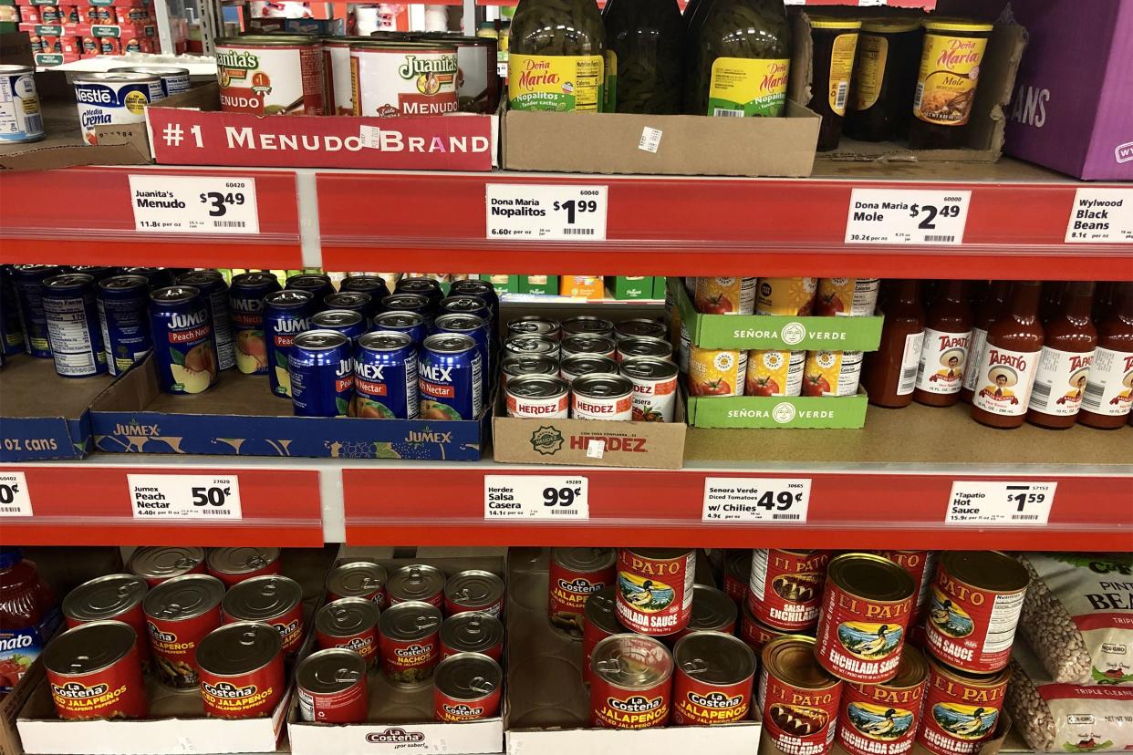 Three shelves of ethnic foods at Save A Alot, well organized, in cans, glass and plastic jars