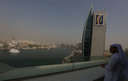 A visitor looks at the aerial view of Dubai from the Deira old Dubai side in Dubai, UAE July 9, 2018. Picture taken July 9, 2018. REUTERS/Satish Kumar