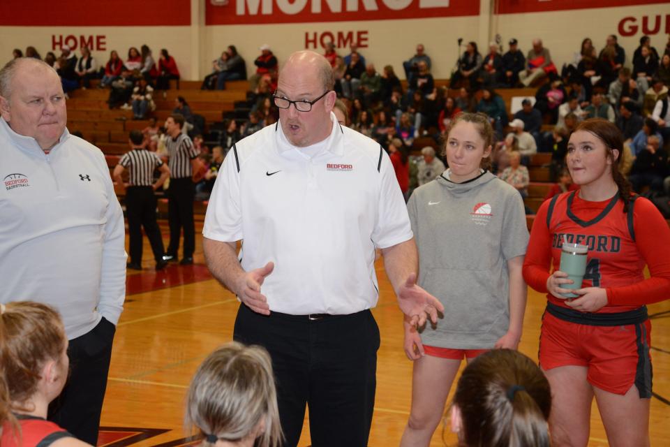 Bedford coach Bill Ryan talks to his team during a 50-7 win over Monroe Friday night.