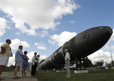 Visitors look at a SS-18 SATAN intercontinental ballistic missile at the Strategic Missile Forces museum near Pervomaysk, some 300 km (186 miles) south of Kiev, August 22, 2011. REUTERS/Gleb Garanich