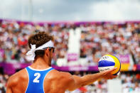 LONDON, ENGLAND - JULY 30: Martin Reader of Canada prepares to serve during the Men's Beach Volleyball Preliminary match between Norway and Canada on Day 3 of the London 2012 Olympic Games at Horse Guards Parade on July 30, 2012 in London, England. (Photo by Ryan Pierse/Getty Images)