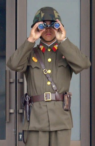 A North Korean soldier at the truce village of Panmunjom in the demilitarized zone that separates the two Koreas. North Korea's new leadership has agreed to suspend nuclear tests and its uranium enrichment programme as part of a deal that includes US food aid for the impoverished nation