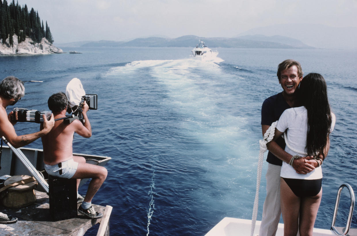 English actor Roger Moore as 007 with French actress Carole Bouquet as Melina Havelock on the set of the James Bond film 'For Your Eyes Only', February 1981. Here they are tied together in readiness for a scene in which they are dragged through shark-infested waters. (Photo by Keith Hamshere/Getty Images)