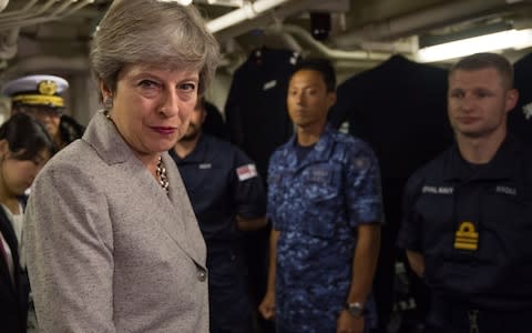 Britain's Prime Minister, Theresa May, meets British and Japanese naval personnel  - Credit: Getty/Carl Court