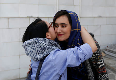 Female students of American University of Afghanistan hug each other as they arrive for new orientation sessions at a American University in Kabul. REUTERS/Mohammad Ismail