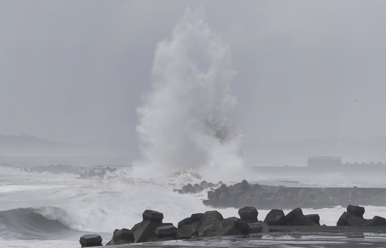 Large waves crash against the breakwaters (AP)