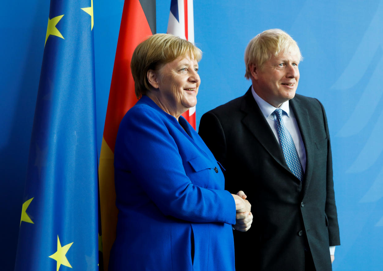 Britain's Prime Minister Boris Johnson and German Chancellor Angela Merkel shake hands as they pose for a photo during a news conference at the Chancellery in Berlin, Germany, August 21, 2019. REUTERS/Axel Schmidt