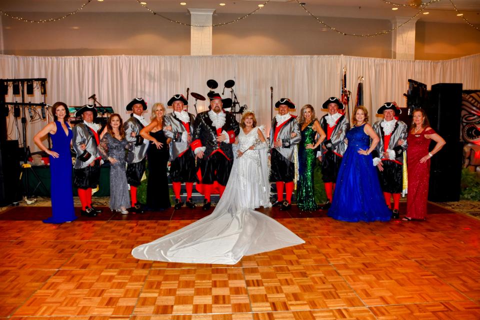 Members of the Krewe of Dominique Youx 2023 court. In the center are King Allen Cotton and Queen Brenda Harned, along with six pirates and six princesses.