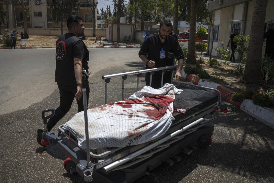 Palestinian medics pull a bloodied gurney from after Israeli airstrikes, in Khan Younis in the Gaza Strip, Wednesday, May 10, 2023. Israeli authorities say Palestinian militants in the Gaza Strip have launched rockets toward southern Israel. Wednesday's launch comes a day after Israeli airstrikes killed three militant leaders and at least 10 civilians. (AP Photo/Fatima Shbair)