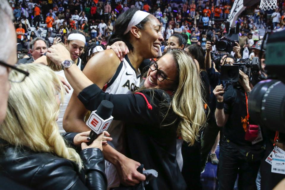 Becky Hammon hugs A'ja Wilson (left) after winning the 2022 WNBA Finals.