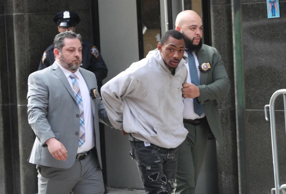 Suspect Carlton McPherson with detectives leaving the 25th Precinct in Manhattan after his arrest. G.N.Miller/NYPost