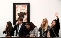 FILE PHOTO: Employees take telephone bids during a contemporary art day auction at Sotheby's in London