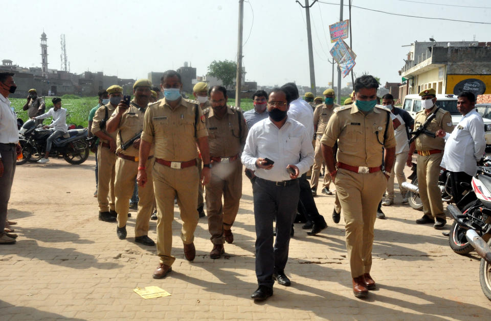 Police and district administration officials at the Dasna Devi temple. (Photo by Sakib Ali/Hindustan Times via Getty Images)