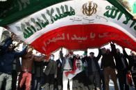 <p>Iranians hold an Iranian flag during a protest after performing the Friday Prayer at Imam Khomeini Mosque followinga U.S. statement about backing the anti-government protests in Tehran, Iran on Jan. 05, 2018. (Photo: Fatemeh Bahrami/Anadolu Agency/Getty Images) </p>